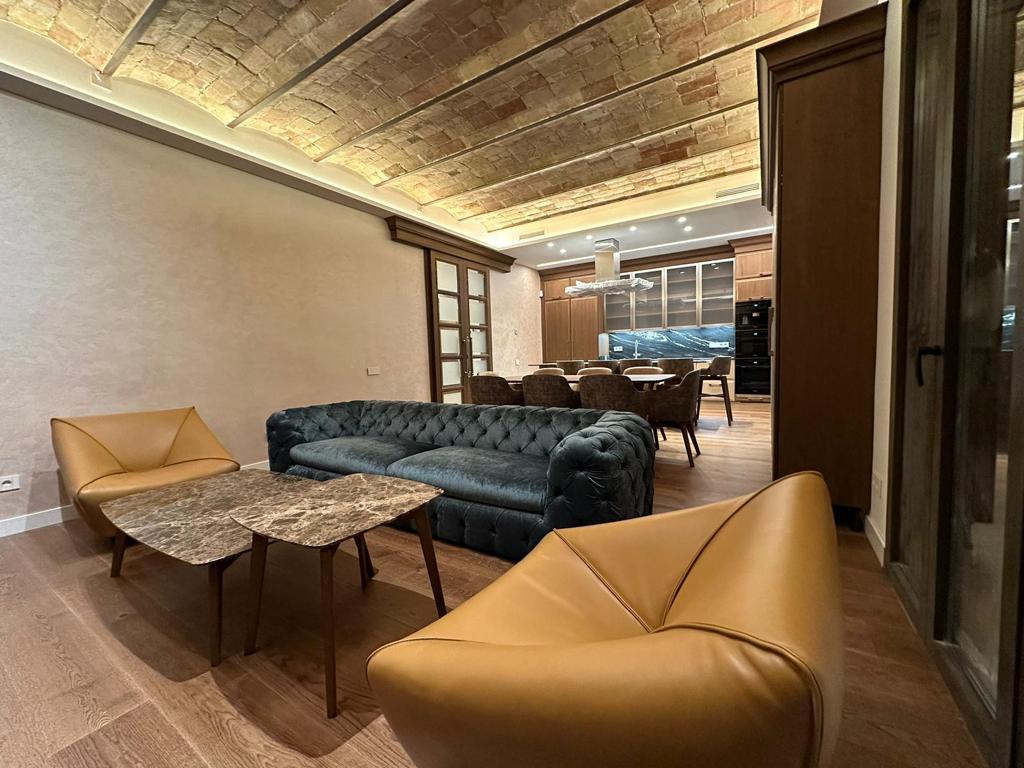 Cucina su misura a Barcellona con area living coordinata e boiserie in legno realizzata da Martini Verona